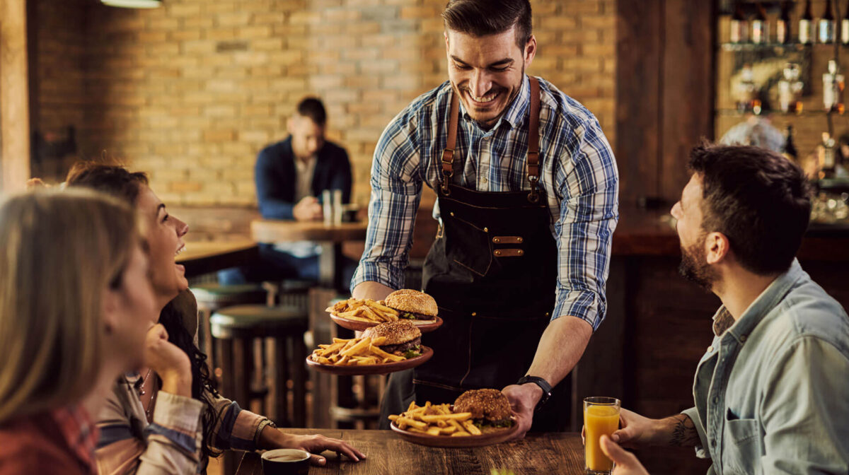 Waiter serving food on the table